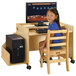 A young girl sitting at a Jonti-Craft wood computer desk with a computer.