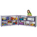 A little girl sitting in front of a purple and white Rainbow Accents storage unit.