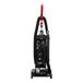 A Sanitaire bagged upright vacuum cleaner with a red handle.