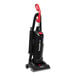 A black and red Sanitaire bagged upright vacuum cleaner.