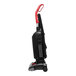 A Sanitaire bagged upright vacuum cleaner with a red handle.