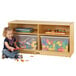 A young girl sitting on the floor playing with Jonti-Craft wood storage totes.