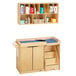 A Jonti-Craft wooden baby changing table with shelves and a blue cabinet.