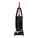 A Sanitaire bagless upright vacuum cleaner with a red handle and hose.