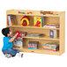 A child sitting on the floor reading a book in front of a Jonti-Craft wood storage cabinet.