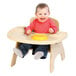 A baby sitting in a Jonti-Craft Wood High Chair with a tray eating.