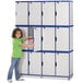 A young girl opening a Rainbow Accents blue and gray laminate locker.