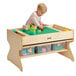 A child playing with Jonti-Craft brick building table.