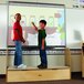 Two young boys standing on a Jonti-Craft iRise platform in a classroom.