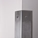 A stainless steel wall corner guard from Advance Tabco installed on a wall corner.