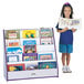 A young girl holding a book on a purple and white Rainbow Accents book rack.