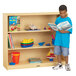 A young boy reading a book in front of a Jonti-Craft classroom book shelf.
