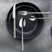 A black plate with Amefa Metropole dessert spoons on it.