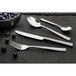 An Amefa stainless steel bouillon spoon on a table.