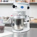 A Globe countertop mixer with a bowl of chocolate chips on the counter.