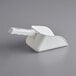 A white plastic Avantco Ice scoop with a handle.