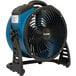 An XPOWER blue and black industrial axial fan on a stand.