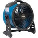 A blue and black XPOWER industrial axial fan with a stand.