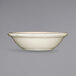 A white stoneware fruit bowl with a black rim.