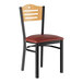 A Lancaster Table & Seating black side chair with a natural wood back and red cushion.