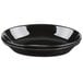 A black Tuxton oval china nesting baker with a white rim.