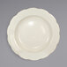 A white stoneware pasta bowl with a scalloped edge.