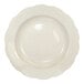 A round ivory stoneware pasta bowl with a scalloped edge.