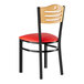 A Lancaster Table & Seating black metal side chair with red vinyl seat.