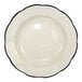A round ivory stoneware pasta bowl with a scalloped edge and a black rim.