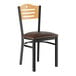 A Lancaster Table & Seating black wooden side chair with a dark brown vinyl seat and natural wood back.