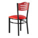 A red and black metal Lancaster Table & Seating side chair with mahogany wood back and red vinyl seat.