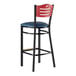 A Lancaster Table & Seating mahogany and black restaurant bar stool with a navy cushioned seat.