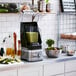 A KitchenAid commercial blender on a counter.