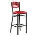 A Lancaster Table & Seating black side bar stool with mahogany wood back and red vinyl seat.