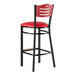 A black Lancaster Table & Seating bar stool with mahogany back and red seat.