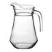 An Acopa clear glass pitcher with a handle.