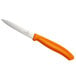 a knife with orange handle