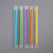 a group of colorful straws in plastic wrappers