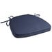 A navy blue Lancaster Table & Seating Chiavari chair cushion with ties.