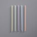 A group of multicolor striped plastic straws.