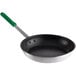 A close-up of a Choice aluminum non-stick fry pan with a green handle.