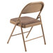 A National Public Seating folding chair with a brown cushioned seat.