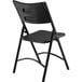 A National Public Seating black metal folding chair with black plastic back and seat.