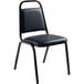 A black National Public Seating stackable chair with a black seat and back and midnight blue upholstery.