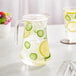 An Acopa glass pitcher of water with lemons and cucumbers.