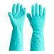 A pair of green Cordova nitrile gloves on a white background.