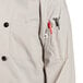 A Uncommon Chef long sleeve chef coat in white with red buttons and a pocket.