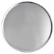 A close-up of a round silver Vollrath pizza pan.