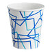 A white paper cup with blue geometric designs.