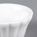 A close up of a CAC Bone White China floral ramekin with a small rim.